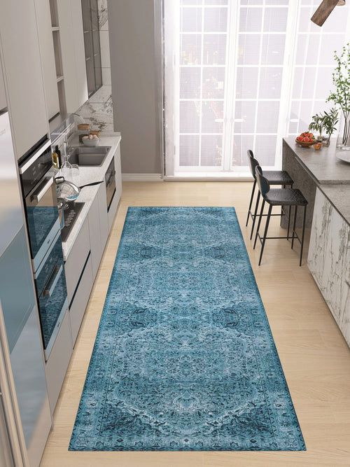 Load image 1 in gallery view. A modern kitchen with light wood floors, gray cabinets, and a Mystic Mosaic - Washable Rug - JRN1019 (Custom Size) leading to a breakfast bar with two black chairs by large floor-to-ceiling windows.