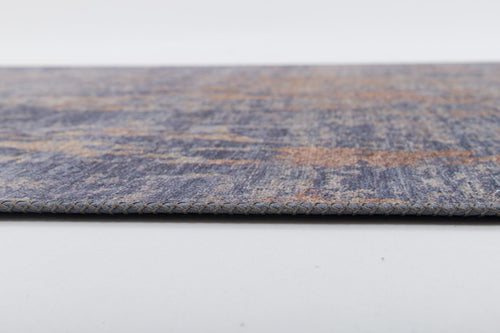 Load image 1 in gallery view. A close-up side view of the Mystical Mosaic - Washable Rug - JRS003 (Outlet) US shows its thin, flat design with a textured blue and brown pattern and braided edge—perfect for high-traffic areas.