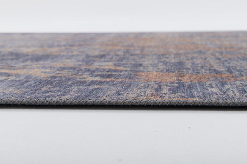Load image 1 in gallery view. Close-up side view of the Mystical Mosaic - Washable Rug - JRS003 (Custom Size), a thin, rectangular rug in blue, beige, and brown with textured surface and detailed edge stitching, ideal for high-traffic areas.