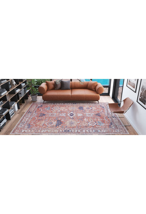 Load image 1 in gallery view. A modern living room with a tan leather sofa, two gray pillows, the Mystral Kilim-Design Coral Washable Rug - LCC3015 for high-traffic areas, a brown chair, bookshelves, a potted plant, and large windows overlooking a pool.