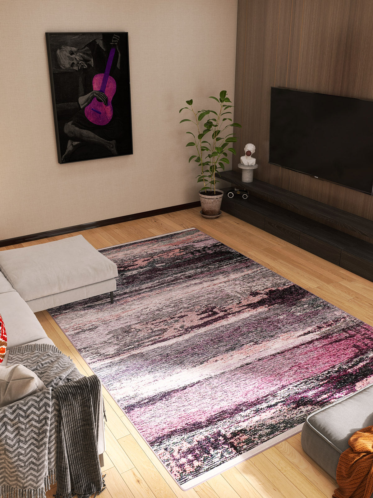 A modern living room with the large Natural Brushed - Washable Rug - JR336, light wood floors, a sectional sofa, potted plant, wall-mounted TV, and framed art of someone playing a purple guitar—perfect for high-traffic spaces.