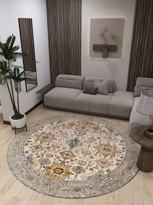 Load image 1 in gallery view. A modern living room features a light gray sectional, neutral decor, an indoor plant, and the Nexa Bordered Beige Washable Rug - LCC3009 (Custom Size) with intricate patterns on a wooden floor—ideal for high-traffic areas.