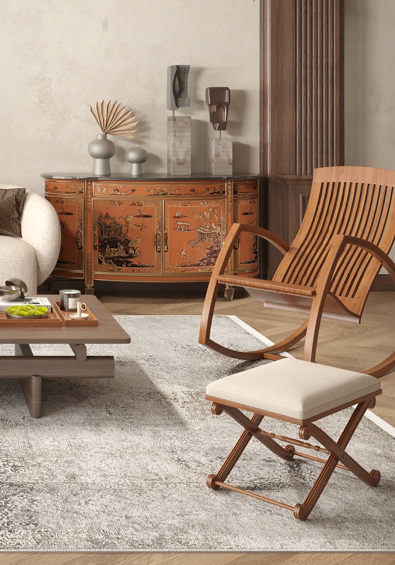 A living room features a cream sofa, wooden coffee table on a Noble Insignia - Washable Rug - JR1830 (Outlet) US, and two wooden chairs. An orange lacquered cabinet with Asian-style art and modern décor stands against the back wall.