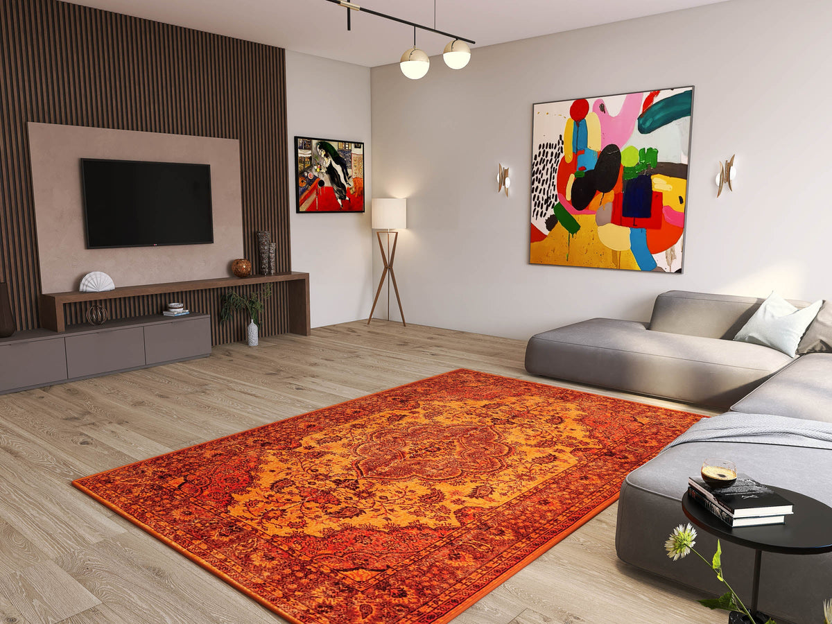Modern living room with light wood floors, a large Noble Odyssey - Washable Rug - JRN1012 (Custom Size) in orange, gray sectional sofa, wall-mounted TV, abstract art, floor lamp, minimalist decor, and sunlight streaming through the window.
