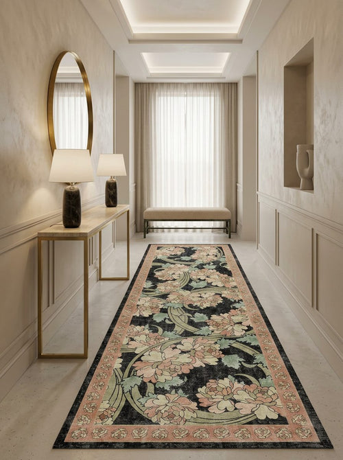 Load image 1 in gallery view. Black runner rug with a floral pattern in pink and sage green, styled in a neutral-toned hallway.