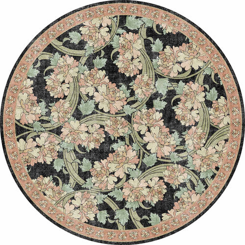 Load image 1 in gallery view. Round rug with a black background, featuring a floral pattern of pink peonies and sage green leaves with a floral border.
