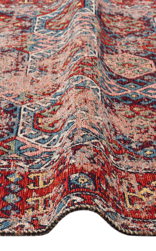 Load image 1 in gallery view. A close-up of the Nomad Spirit - Washable Kilims - AND03 shows its red, blue, and beige tribal patterns with a raised ripple, highlighting the intricate flatwoven texture and weave of this unique rug.