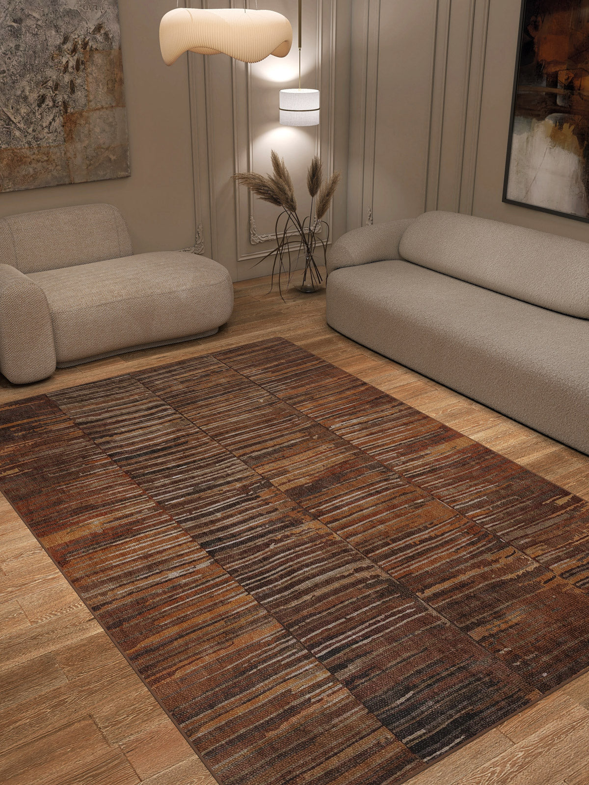 A modern living room with two light beige sofas, wooden flooring, neutral decor, and the Nostalgic Weft - Washable Rug - JRN33—durable and ideal for high-traffic areas—plus a pendant light, pampas grass in a vase, and abstract wall art.