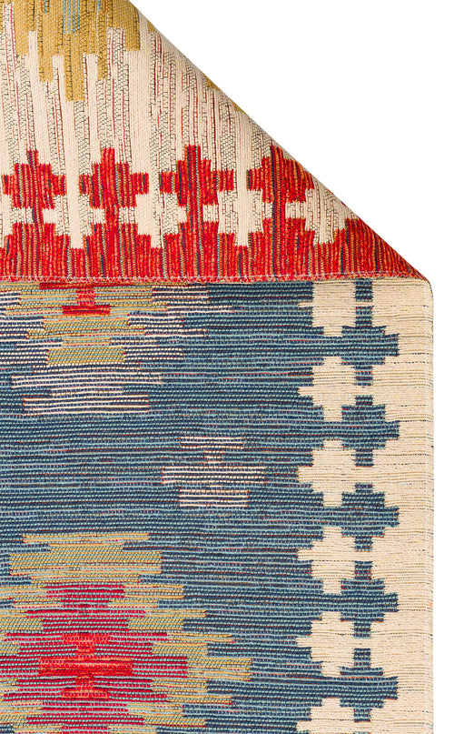 Bild 1 in Galerieansicht laden. The Ocean Form - Washable Reversible Kilim - NMD04 features blue tribal geometric patterns in red, yellow, and white. A folded top corner reveals the detailed, colorful design of this vibrant and washable rug.