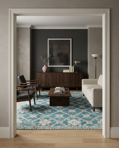 Load image 1 in gallery view. A modern living room with a beige sofa, two dark armchairs, a wooden coffee table, and the Ocean Trellis Area Rug APX1942. A dark accent wall displays large framed art above a wooden sideboard decorated with accents.
