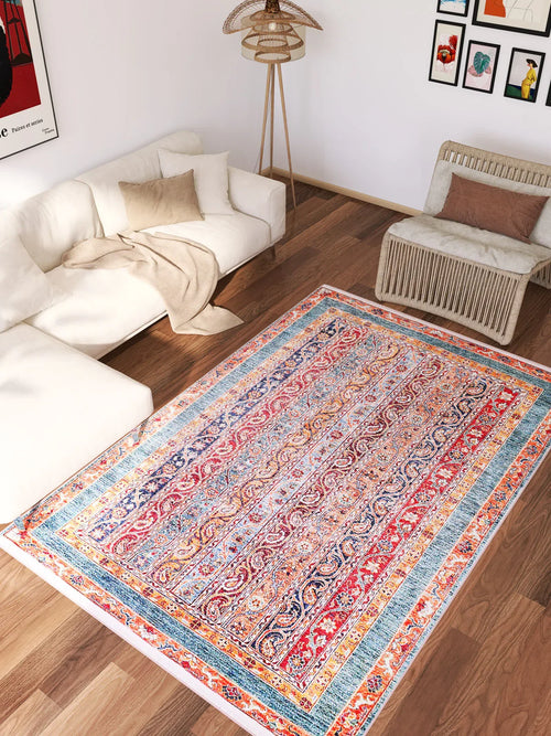 Load image 1 in gallery view. The Old-World Elegance - Washable Rug - JR38, featuring red, blue, and yellow patterns, adds a vibrant touch to a modern living room with wooden floors—perfect for high-traffic areas.