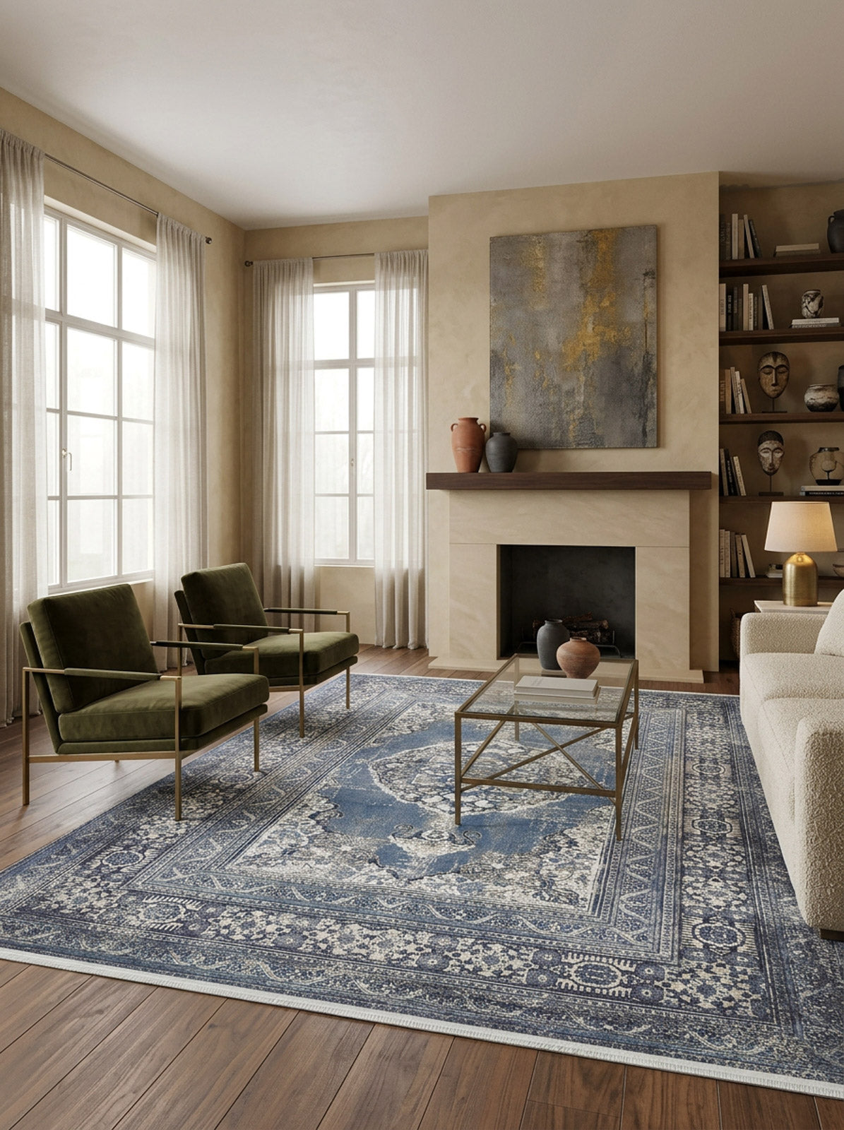 A modern living room with large windows, sheer curtains, two green armchairs, a white sofa, the Opulent Beauty - Washable Rug - JR1932 ideal for high-traffic areas, a glass coffee table, fireplace, and built-in shelves adorned with art and decor.