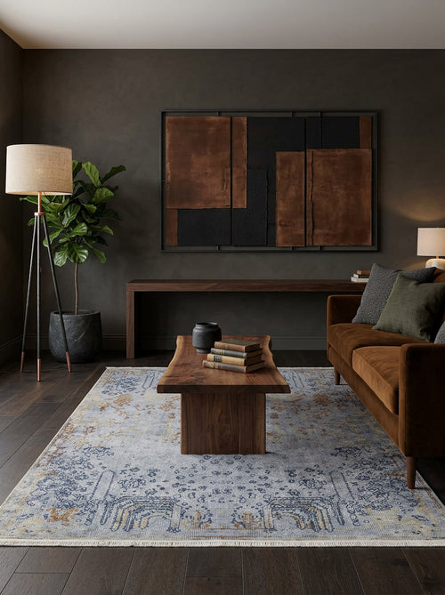 Bild 1 in Galerieansicht laden. Light blue and gold distressed traditional rug with a faded medallion pattern, styled in a dark modern living room.