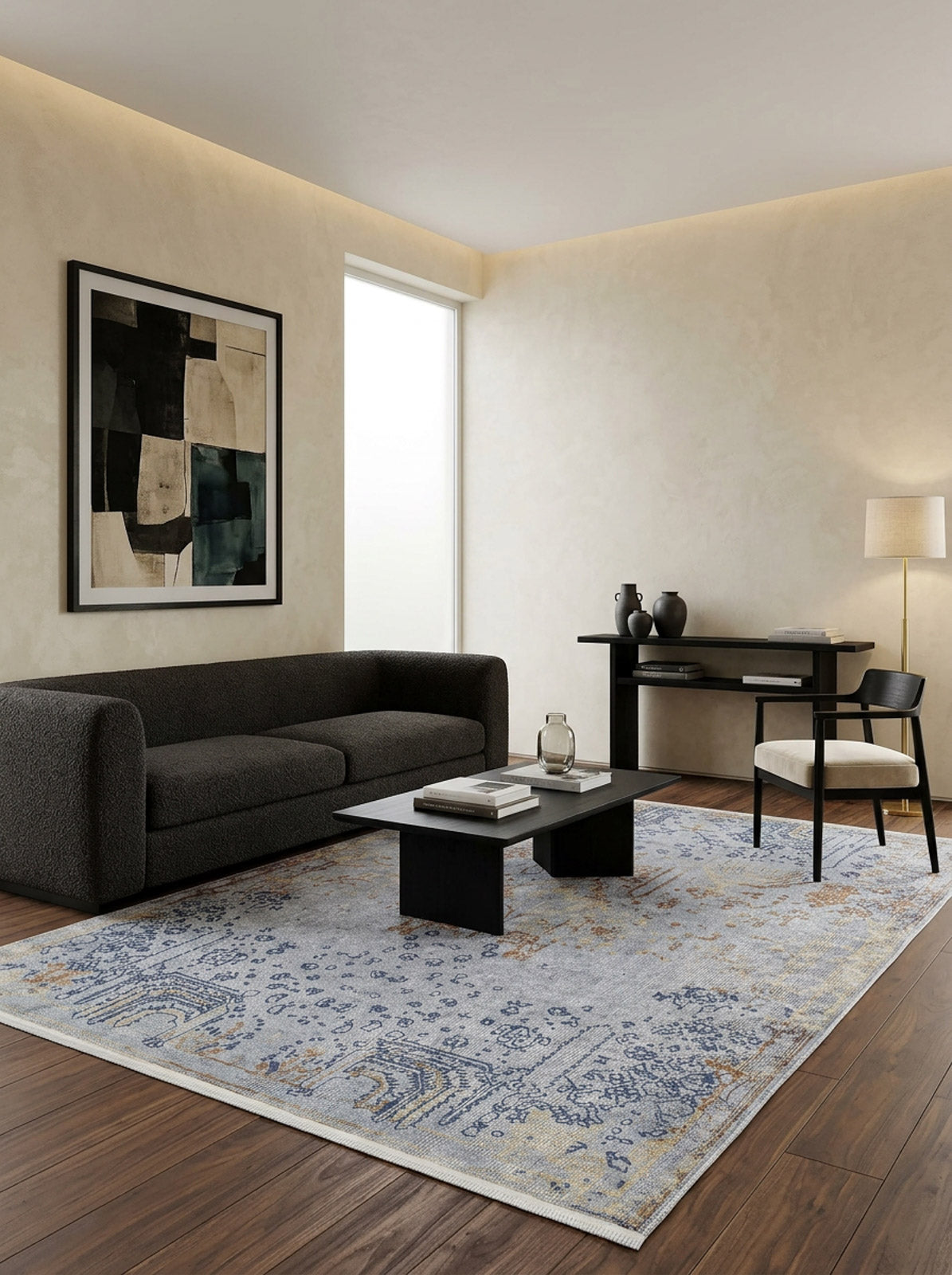 Light blue and tan traditional distressed medallion rug in a modern living room with dark furniture.