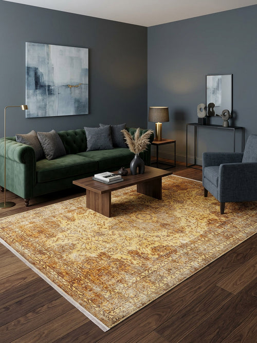 Bild 1 in Galerieansicht laden. Distressed gold and ochre traditional medallion rug in a modern living room with a green velvet sofa.