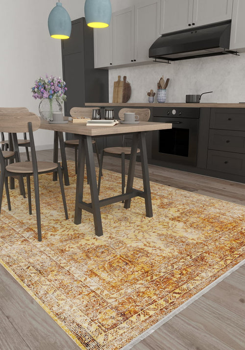 Bild 1 in Galerieansicht laden. A modern kitchen with gray cabinets, a wooden dining set, pendant lights, a vase of purple flowers on the table, and the Ornate Beauty - Washable Rug - JR206 in a yellow pattern—ideal for busy, high-traffic spaces.