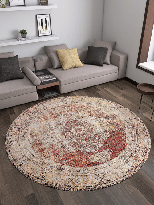 Load image 1 in gallery view. A modern living room with light gray sectional sofas, neutral cushions, wooden floors, and the Ornate Grace - Washable Rug - JR1009 in red, beige, and gold—ideal for busy spaces. Decorative shelves with books hang above the sofa.