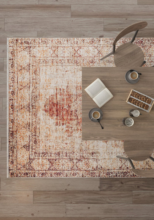 Load image 1 in gallery view. An overhead view of a wooden table with two chairs on the Ornate Grace - Washable Rug - JR1009 (Outlet) US, perfect for high-traffic areas. The table holds an open book, two coffee cups, cookies, and a small dish with a spoon on light wood flooring.