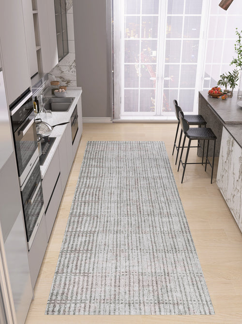 Load image 1 in gallery view. Modern kitchen with light wood floors, gray cabinets, built-in appliances, marble backsplash, and a custom-size Ornate Hues – Washable Rug (JRN38); breakfast bar with black stools and large windows—ideal for contemporary interiors.