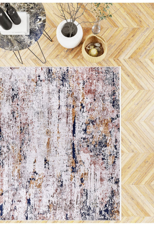 Load image 1 in gallery view. A modern room showcases the Painted Dreams - Washable Rug - JR432 with abstract textures on a herringbone floor, paired with a marble side table, books, bottles, a white vase, and a woven basket—ideal for high-traffic spaces.