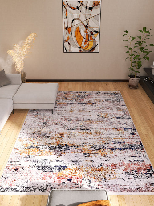 Load image 1 in gallery view. Bright living room with the Painted Dreams - Washable Rug - JR432 (Custom Size) in orange, yellow, and blue—ideal for high-traffic areas. Features a gray sectional, green potted plant, minimalist wall art, and light wood flooring.