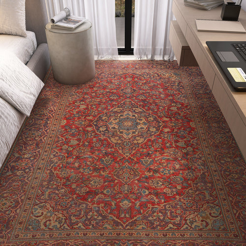 Load image 1 in gallery view. The Palatial Grace - Washable Rug - JRN1021 (Custom Size), featuring intricate vintage medallion and floral patterns, covers the floor beside a bed, near a round ottoman and desk with a laptop in a sunlit bedroom.