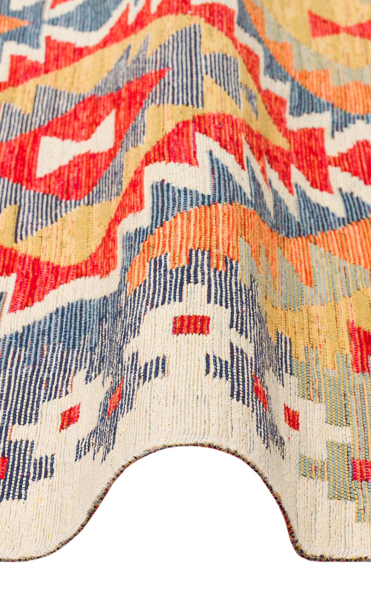 A close-up of the Pastel Grid - Washable Reversible Kilim - NMD09 shows a colorful geometric pattern in red, blue, orange, and cream. The Southwestern rug is folded to highlight its rich texture and substantial thickness.