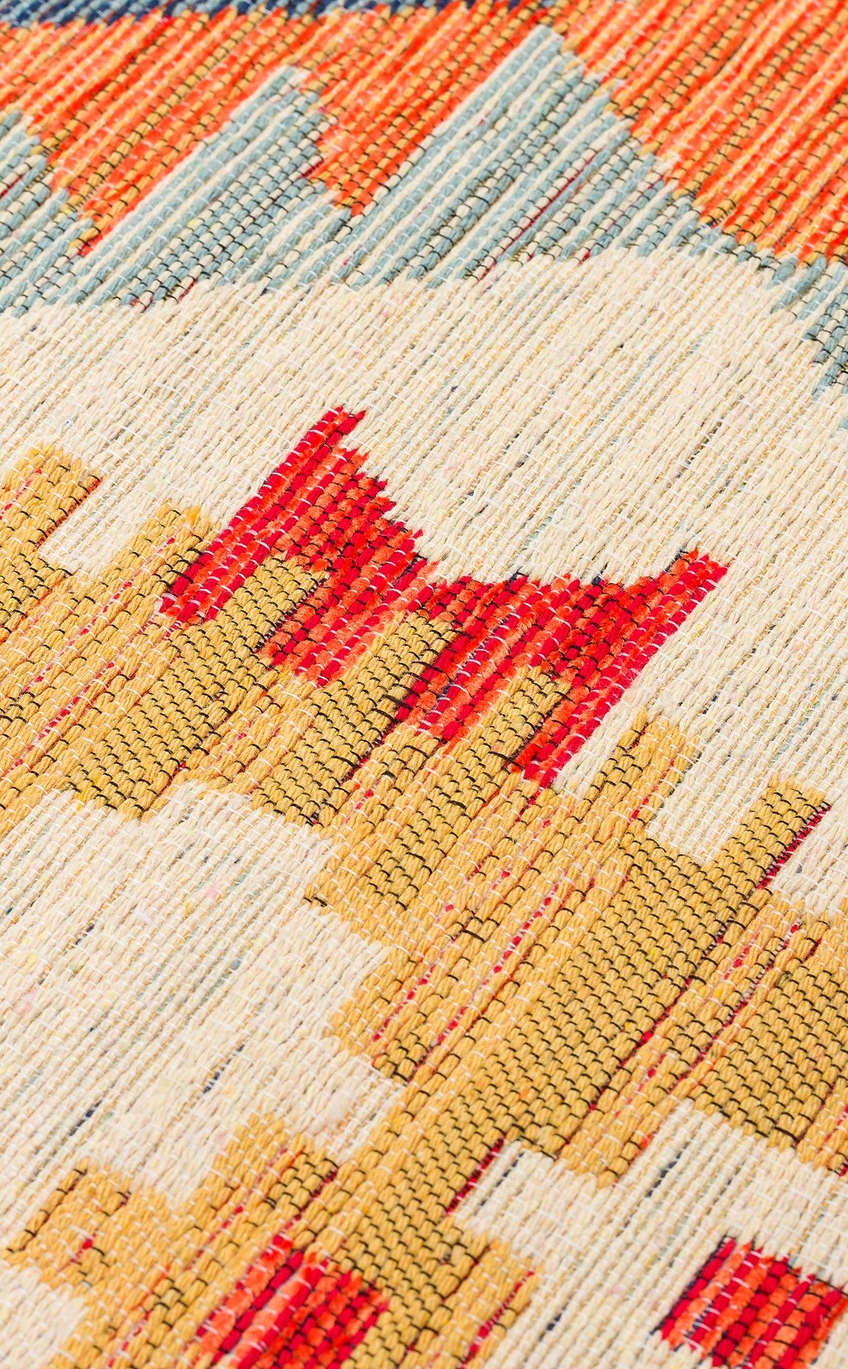 Close-up of the Pastel Grid - Washable Reversible Kilim (NMD09) featuring geometric patterns in red, yellow, orange, and blue on a cream background, highlighting its intricate texture and colorful design.