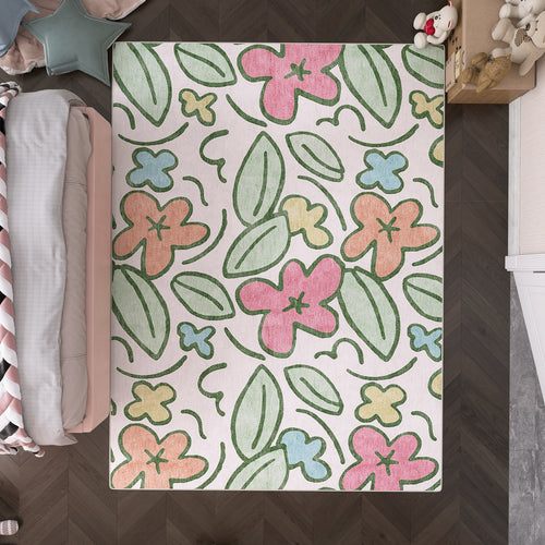 Load image 1 in gallery view. Off-white rug with a colorful floral and leaf pattern in a child's bedroom.