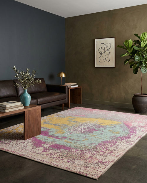 Load image 1 in gallery view. Abstract multi-colored rug with pink, yellow, and teal distressed patches in a modern living room.