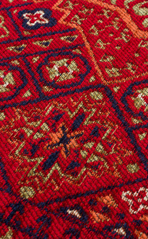 Load image 1 in gallery view. Close-up of the Patch Bloom - Kilim - BHR10 rug, showing intricate geometric and floral patterns in shades of red, navy blue, green, and orange with a clearly visible woven fiber texture.