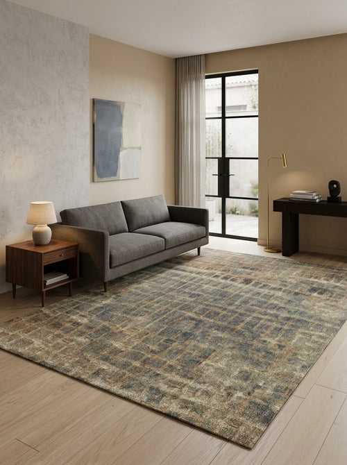 Bild 1 in Galerieansicht laden. Distressed blue and brown grid-patterned rug in a modern living room with a grey sofa.