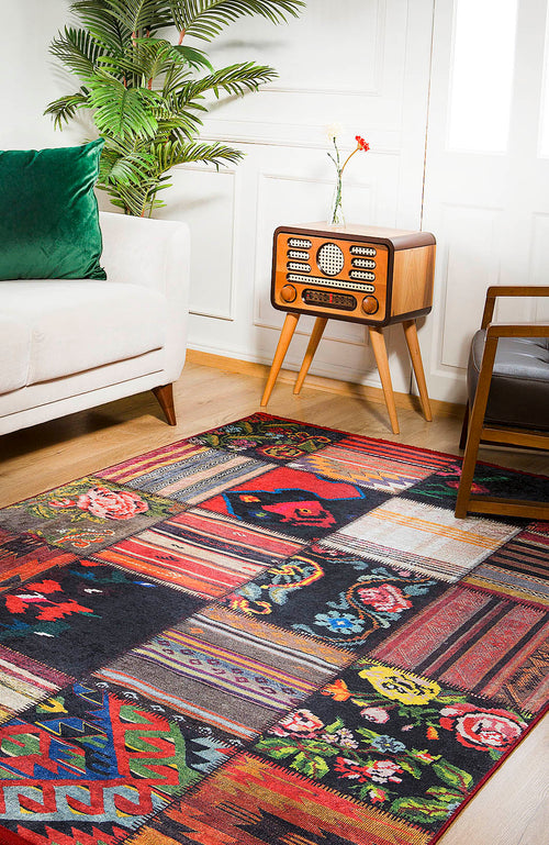 Load image 1 in gallery view. The Petal Paradise - Washable Rug - JR315 (Custom Size) with vibrant geometric and floral patterns brightens a wooden floor beside a white sofa, making it ideal for high-traffic spaces and adding a cozy touch to the room.
