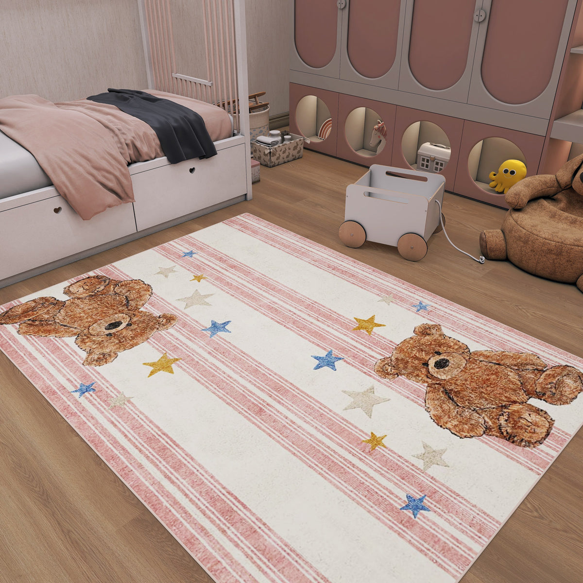 Cream rug with pink stripes, teddy bear motifs, and scattered stars, styled in a child's bedroom.