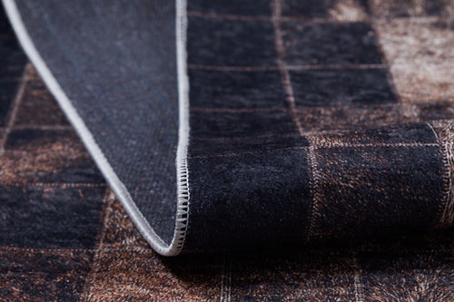 Load image 1 in gallery view. A close-up of the Pinstripe Paradise - Washable Rug - JR1004 (Custom Size) shows its dark brown and black bronze pattern, white stitched edge, textured surface, and underside as the washable rug is partially folded.