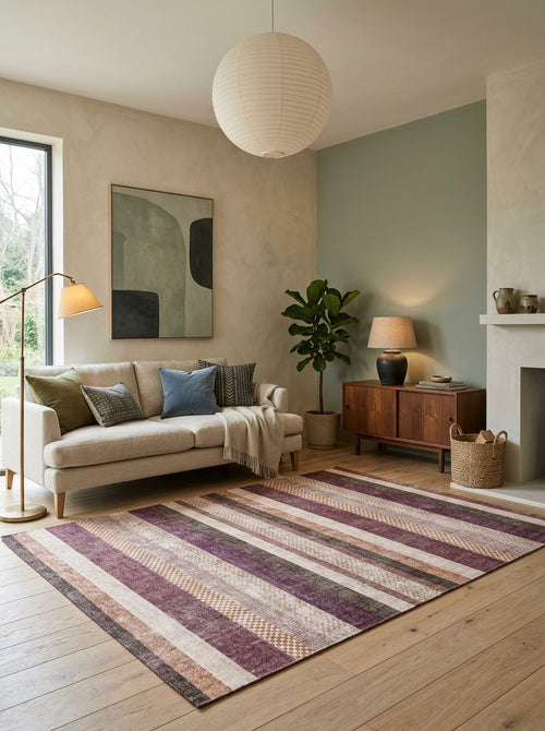 Load image 1 in gallery view. Multi-colored striped rug with textured geometric bands in plum, beige, and brown, styled in a modern living room.