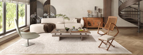 Load image 1 in gallery view. Modern living room with large windows, a white curved sofa, low wooden coffee table, two accent chairs, and a folding screen with crane designs. The Pure Bliss - Washable Rug - JR745 adds warmth and style, perfect for high-traffic, sunlit spaces.