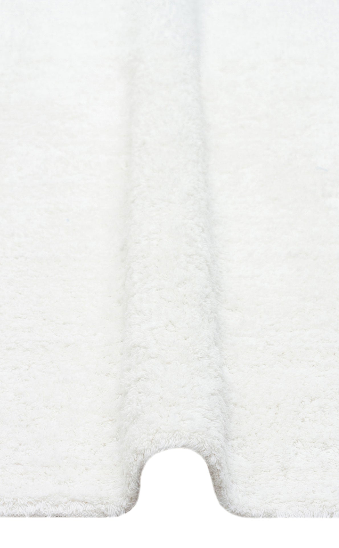 A close-up of the Pure Thread - Washable Shaggy - CBNPLAIN shows its soft, white textured surface with a curved groove in the center, resembling a plush machine-washable rug.
