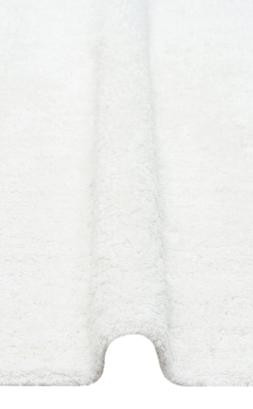 Load image 1 in gallery view. A close-up of the Pure Thread - Washable Shaggy - CBNPLAIN shows its soft, white textured surface with a curved groove in the center, resembling a plush machine-washable rug.
