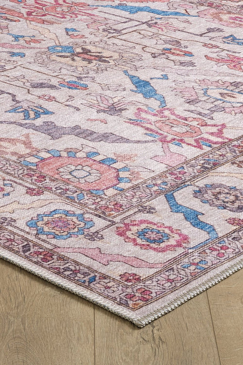 Load image 1 in gallery view. A close-up of the Quasar Traditional Washable Rug - LCC3024 (Custom Size), featuring pink, blue, and cream floral-geometric patterns with intricate borders and textured detailing, ideal for high-traffic areas on wooden floors.