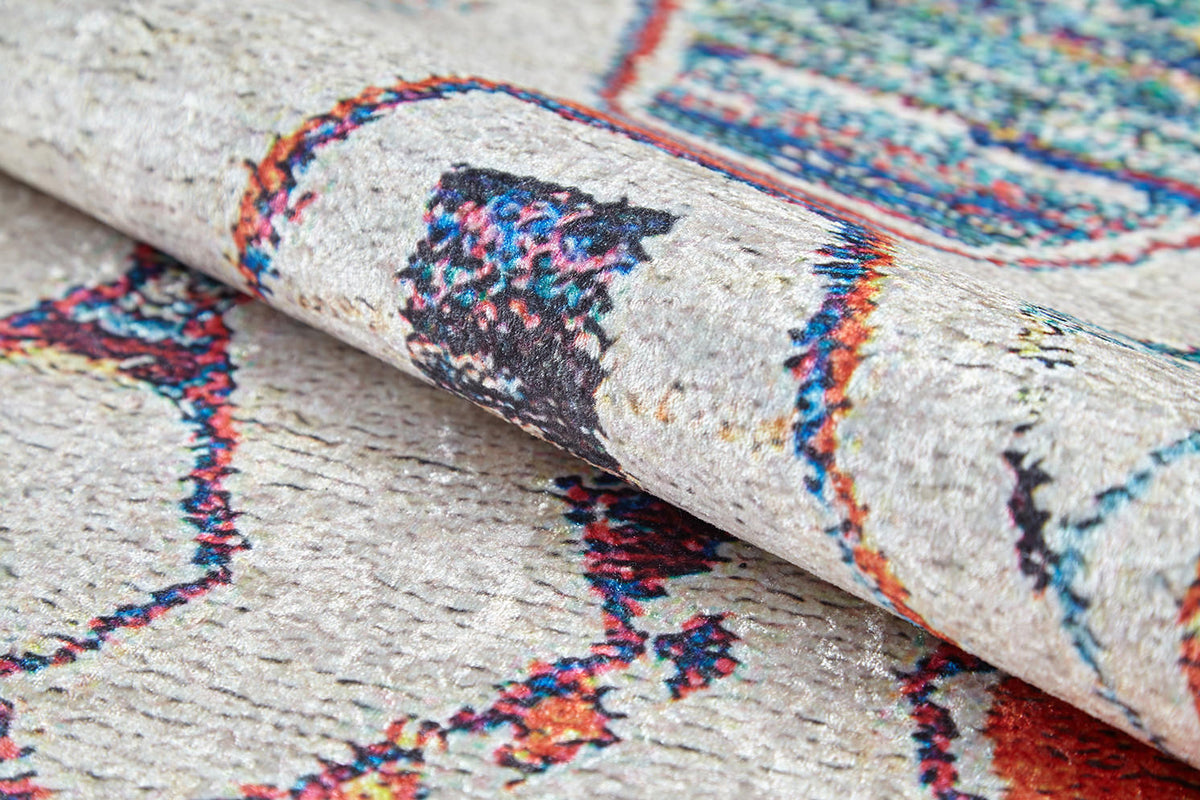 A close-up of the Rainbow Rhapsody - Washable Rug - JR5060 (Custom Size) shows its textured surface and vibrant red, blue, and green abstract patterns on a light background—perfect for allergy-prone households or high-traffic spaces.
