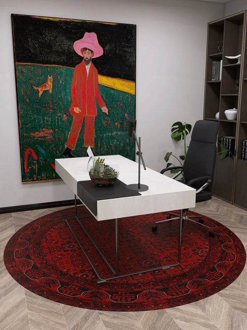 Load image 1 in gallery view. A modern office with a white desk, black chair, and the Regal Accents - Washable Rug - JR36 in red—ideal for high-traffic areas. Behind the desk hangs a vibrant painting of a person in pink and red on grass with a dog. Shelves with books line the right wall.