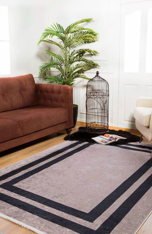 Load image 1 in gallery view. A modern living room with a brown sofa, beige armchair, green plant, and empty black birdcage sits on the Regal Trellis - Washable Rug - JR601 (Custom Size). A magazine rests on the rug over grey carpet—perfect for high-traffic areas.