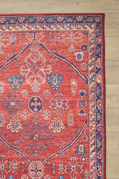 Load image 1 in gallery view. The Rhapsody Authentic Red Washable Rug - LCC3033 (Outlet) US features geometric and floral patterns in red, blue, cream, and orange—ideal for high-traffic areas and stunning on light wood floors.