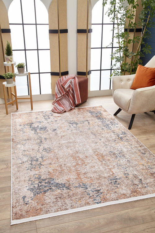 Bild 1 in Galerieansicht laden. A modern living room featuring the Rhythmic Ripples - Washable Rug - JR1637 (Custom Size) in cream and beige, a beige armchair with an orange pillow, a brown ottoman with a striped blanket, a plant, and large windows bright with natural light.