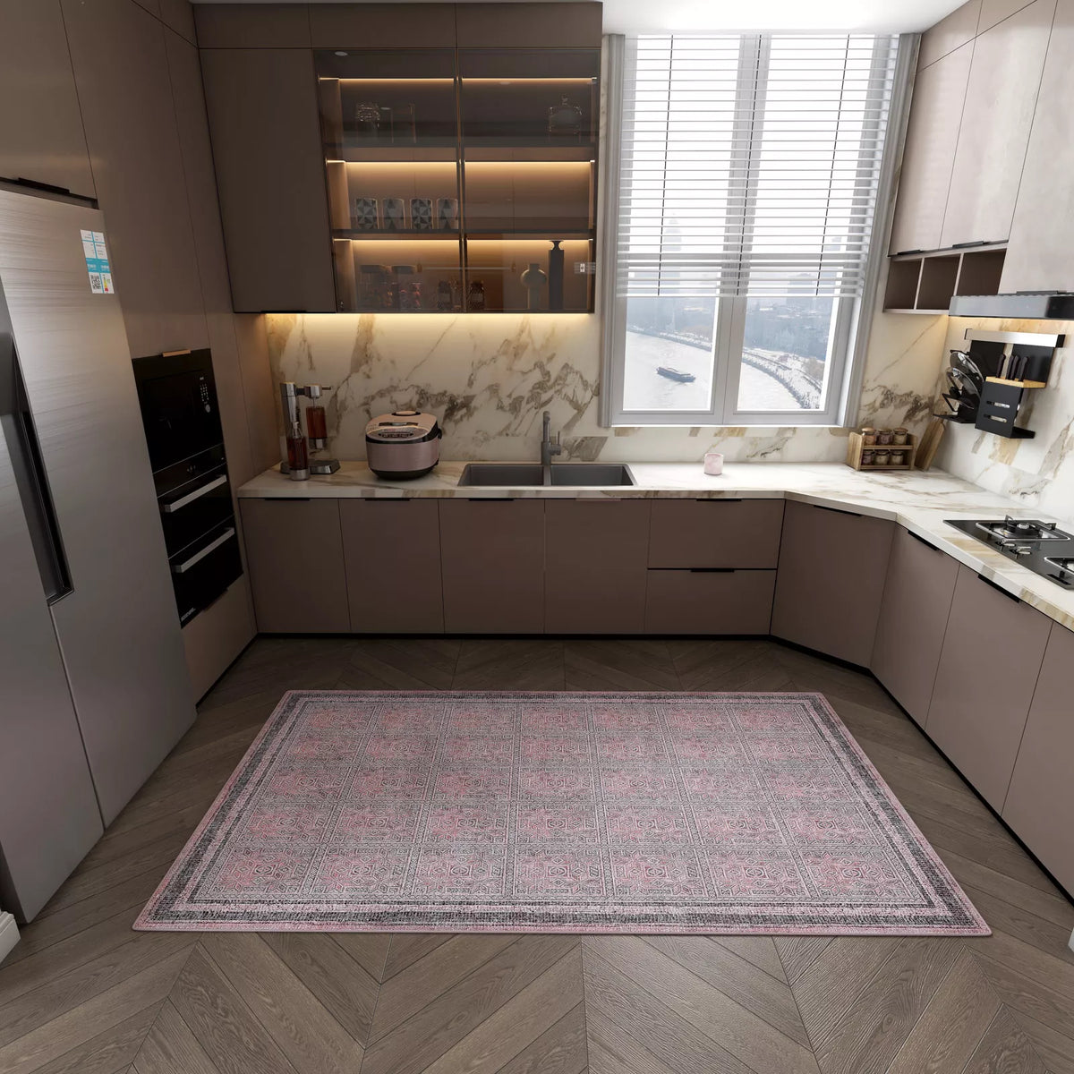 Modern kitchen with sleek brown cabinets, marble countertops, built-in appliances, and a large window with blinds. The wooden herringbone floor is decorated with the Rose Panel - Washable Rug - JRN1035 (Custom Size).