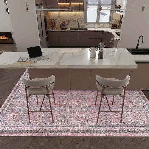 Load image 1 in gallery view. A modern kitchen with a marble island, two cushioned barstools, a laptop, potted plants, and neutral-tone cabinets; the floor features the Rose Panel - Washable Rug - JRN1035 (Custom Size) in pink.
