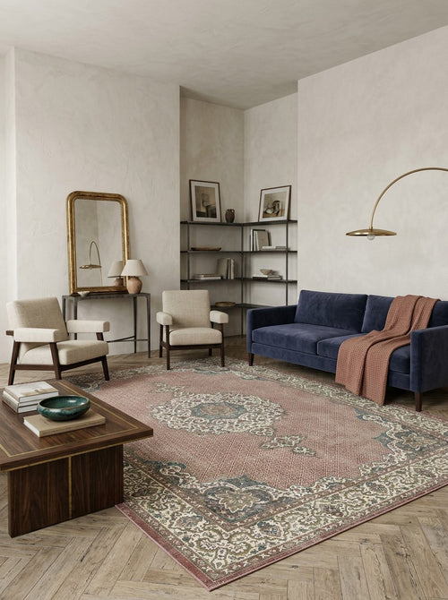 Load image 1 in gallery view. Dusty rose and sage green traditional medallion rug in a modern living room with a navy sofa.