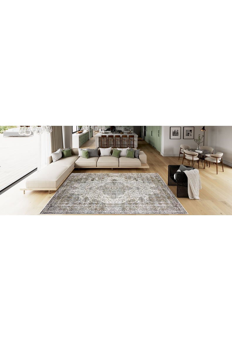 Spacious modern living room featuring the Royal Legacy - Washable Rug - JR207 (Custom Size), an L-shaped beige sofa with green and gray pillows, wooden flooring, and a dining area—ideal for high-traffic spaces.