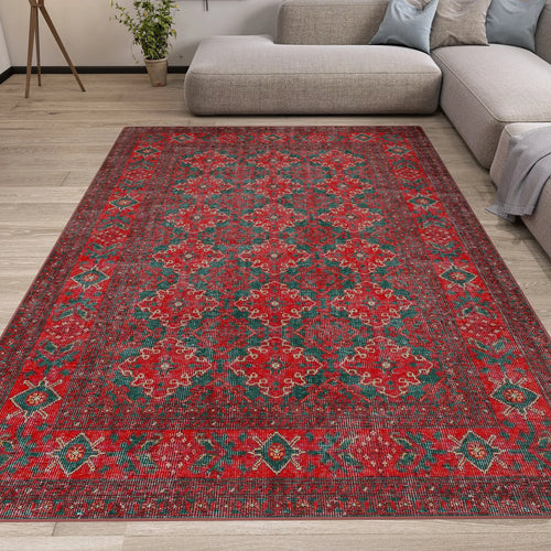 Load image 1 in gallery view. The Ruby Medallion - Washable Rug - JRN1031 (Custom Size) features red patterns with green and gold accents, shown on a light wood floor in a modern living room with a gray sectional, making it perfect for high-traffic or allergy-sensitive spaces.